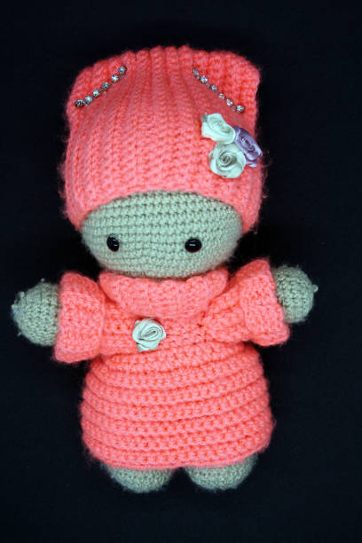 istock A doll made of yarn on a black background. 1330167129