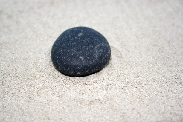 istock Sea round stones on the fine sand. Selective focus. 1330167145