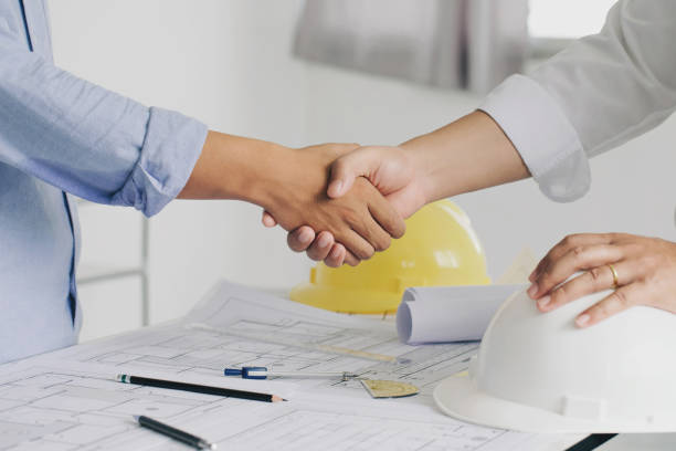 istock Shaking hands of collaboration, Construction engineering or architect discuss a blueprint while checking information and conference new project plan , contract for both companies, success, partnership concept. 1330167173