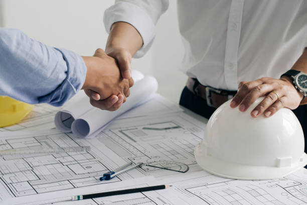 istock Shaking hands of collaboration, Construction engineering or architect discuss a blueprint while checking information and conference new project plan , contract for both companies, success, partnership concept. 1330167240