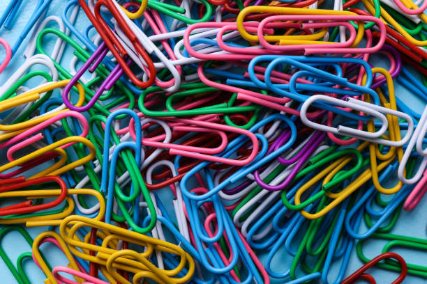 istock Heap of different paper clips as background, top view 1330172121