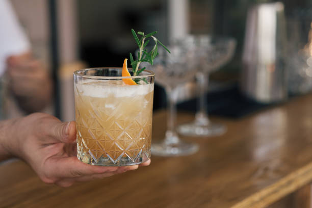 istock Rosemary gin cocktail. Hands holding glass. 1330172800
