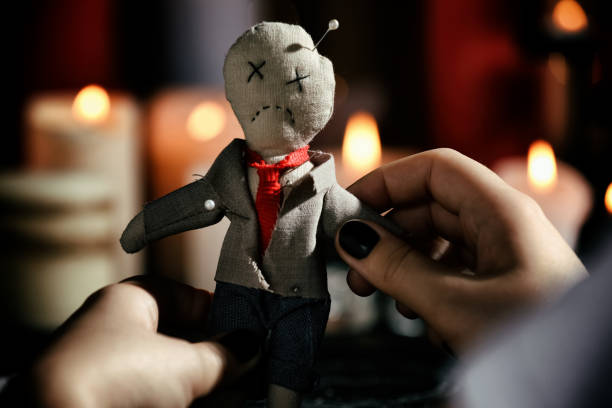 Woman holding voodoo doll with pins indoors, closeup. Curse ceremony Woman holding voodoo doll with pins indoors, closeup. Curse ceremony revenge stock pictures, royalty-free photos & images