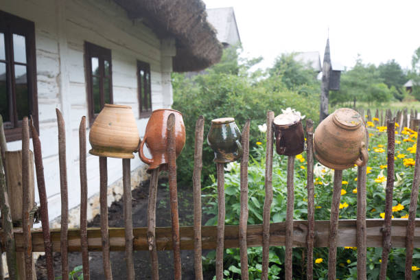 Pots on the old fence near old house