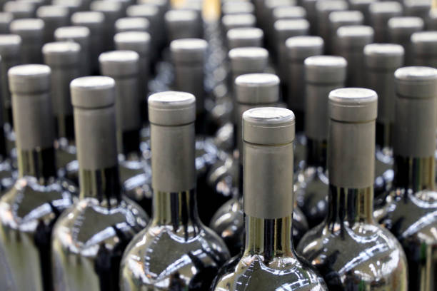 istock Bottles with red wine in a row, selective focus 1330174222