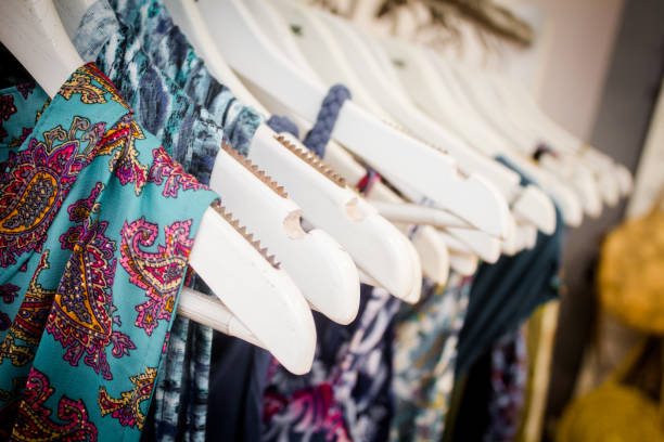 Detail of summer dresses hanging on hangers during the summer sales. stock photo