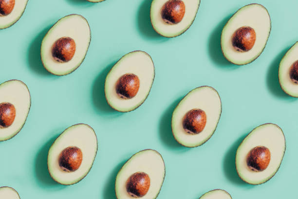istock top view of cut avocado on green background 1330176406