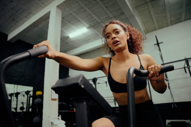 istock African American female using an elliptical trainer during cross training. Female athlete working out in the gym. High quality photo 1330176789