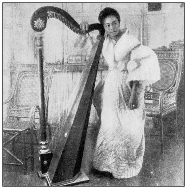 Antique black and white photograph: Tagalog Woman, Philippines Antique black and white photograph of people from islands in the Caribbean and in the Pacific Ocean; Cuba, Hawaii, Philippines and others: Tagalog Woman, Philippines string instrument photos stock illustrations