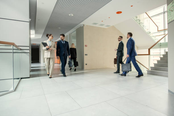 istock Business people walking through the office corridor 1330177951