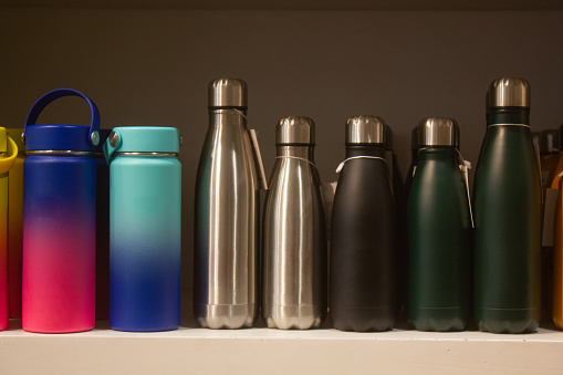 Several ecofriendly reusable water bottles placed on a shelf