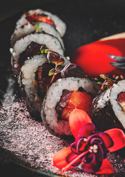 istock sushi roll in plate on black wooden table background 1330188342