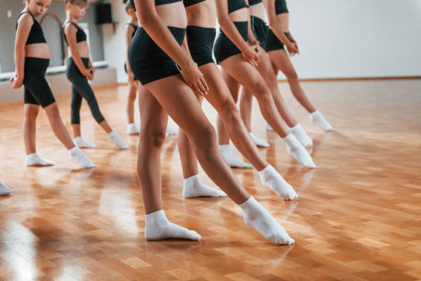 istock Group of female kids practicing athletic exercises together indoors 1330188656