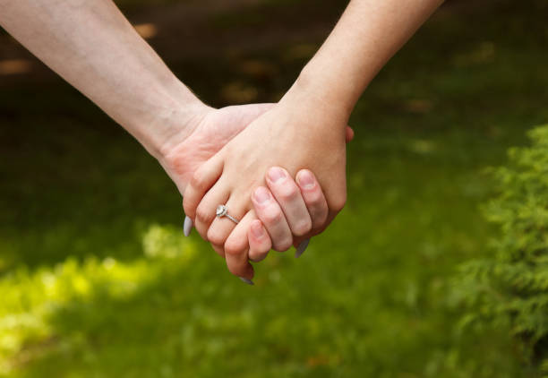 istock man and woman hold hands. hands closeup 1330189360