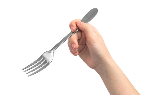 istock Woman hand using steel fork, isolated on a white background photo 1330192025