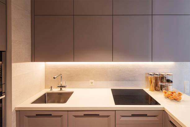 istock Ergonomic modern kooking space with sink, cutting table and electrical stove 1330192427