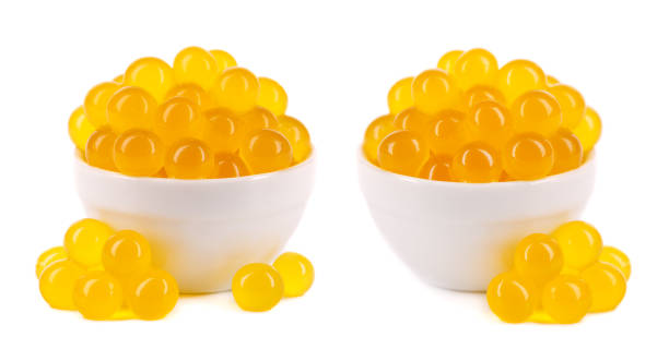 istock Yellow tapioca pearls for bubble tea isolated on white background. Tapioca pearls in ceramic bowl. 1330197576