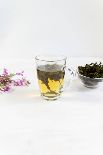 istock Cup of herbal tea with willowherb or chamaenerion on white background 1330197715