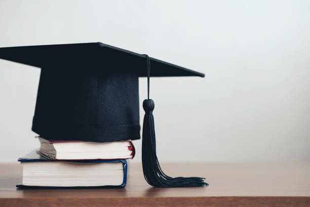 graduation cap on a stack of books with empty space to the right.Graduation concept graduation cap on a stack of books with empty space to the right.Graduation concept dissertation photos stock pictures, royalty-free photos & images