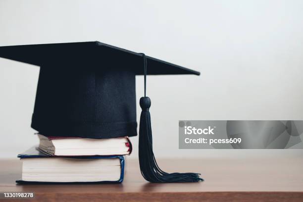 Graduation Cap On A Stack Of Books With Empty Space To The Rightgraduation Concept Stock Photo - Download Image Now