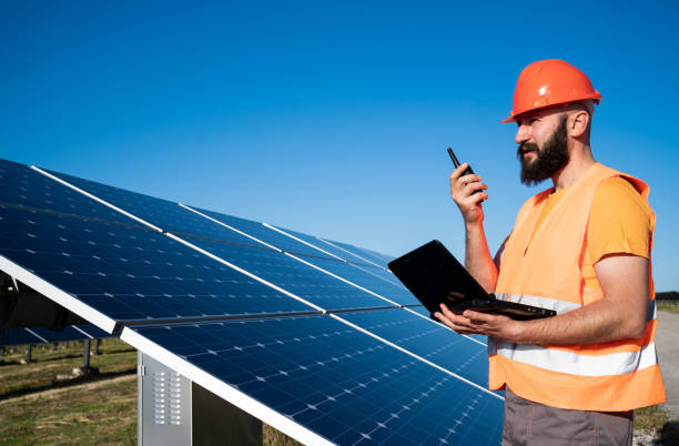istock Operation and maintenance in solar power plant ; engineer working on checking the solar panels   for innovation of green energy for life 1330198571