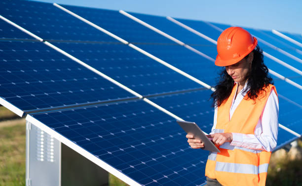 istock Operation and maintenance in solar power plant ; female engineer, holding notepad, working on checking the solar panels   for innovation of green energy for life 1330198573