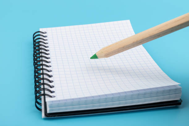 istock Blank paper and pencil on a blue background 1330199124