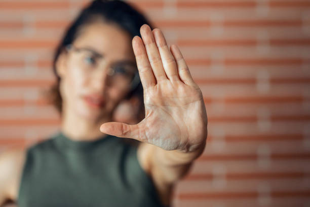 istock Fighter woman making stop sign with hands while saying no looking at camera. 1330200123