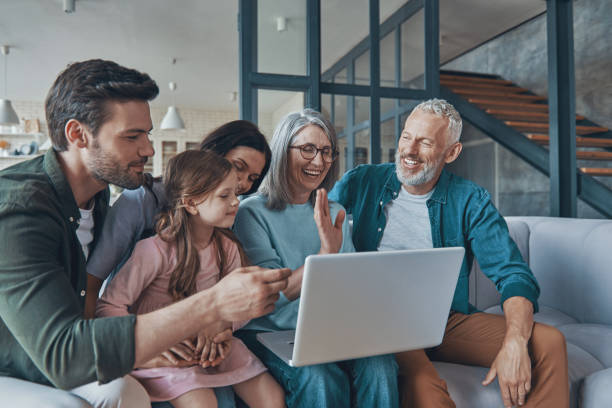 istock Happy family using laptop and smiling 1330202965