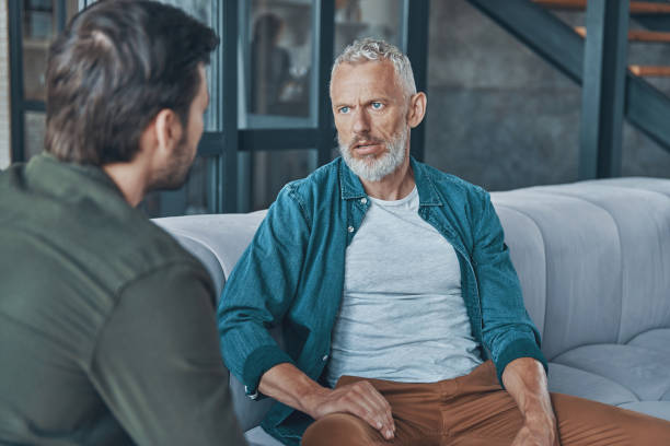 istock Young man talking to his senior father 1330203043