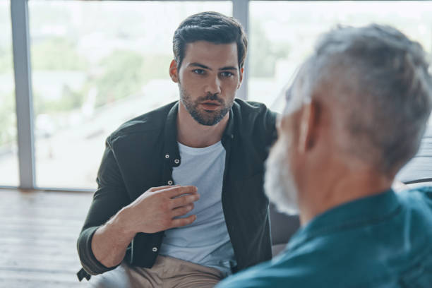 istock Handsome young man talking to his senior father 1330203121
