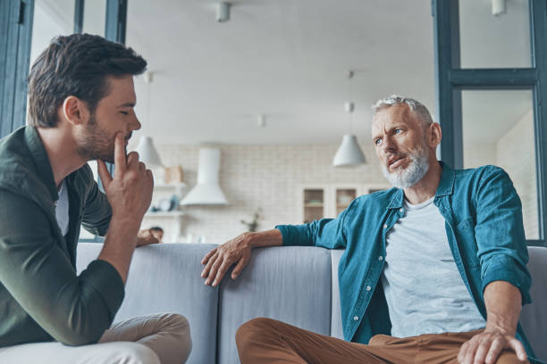 istock Handsome young man talking to his senior father 1330203226