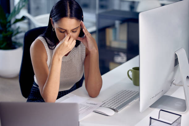 istock Shot of a female call center worker experiencing a headache at work 1330204381
