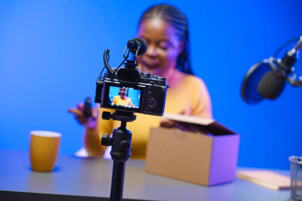 istock A dark-skinned girl curiously opens a cardboard box. 1330204516