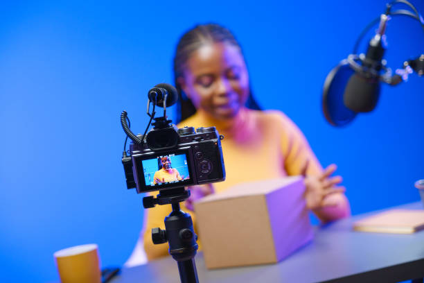 istock The camera in the studio shoots a blogger who will unpack a cardboard box. 1330204517