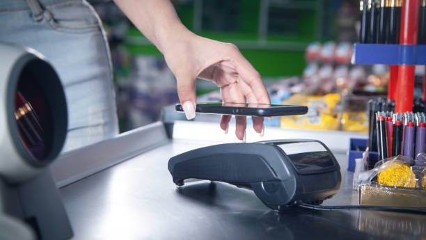 istock Customer paying for purchases contactless with smartphone. 1330204540