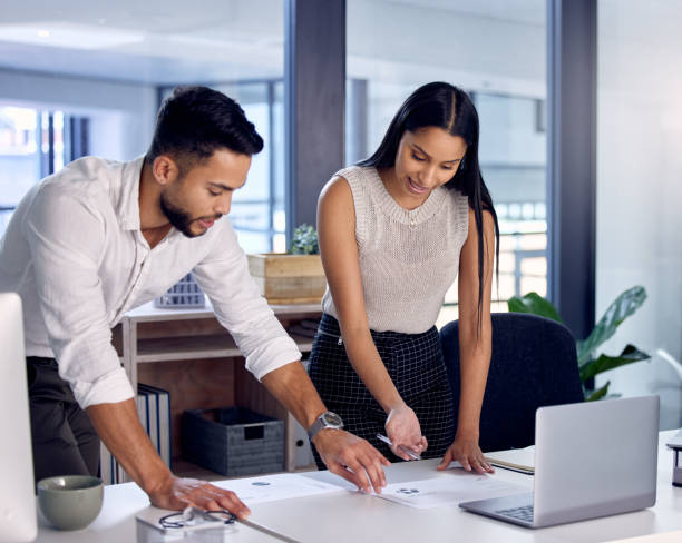 istock Shot of two work colleagues reading over some documents together 1330204905