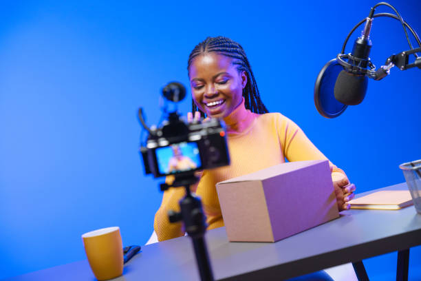 istock A dark-skinned girl has just received a new gadget ordered from an online store. 1330205594