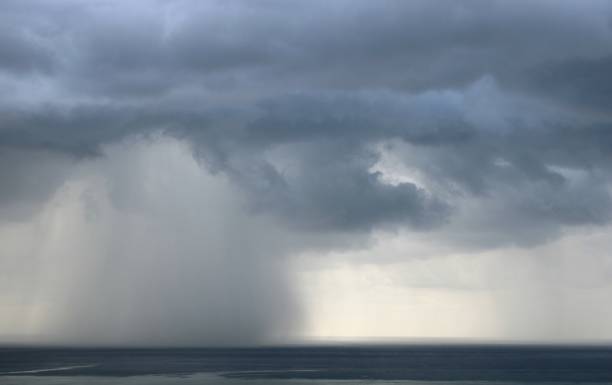 istock Dark storm clouds and heavy rain over the sea 1330205649