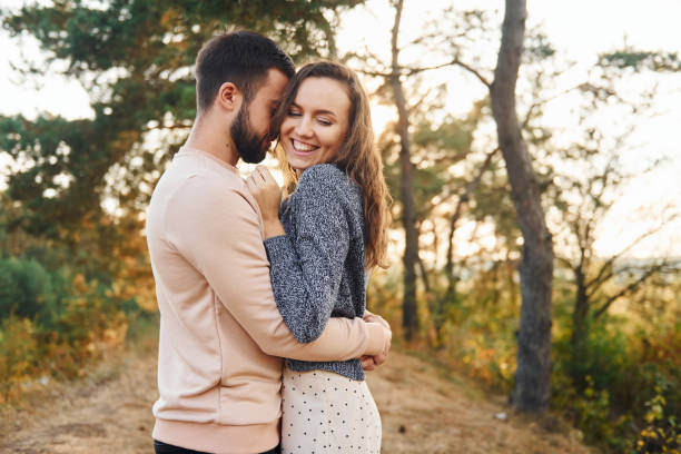 istock Embraces each other. Cheerful lovely young couple having a rest outdoors together 1330207104