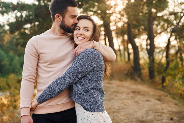 istock Embraces each other. Cheerful lovely young couple having a rest outdoors together 1330207187