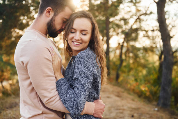 istock Embraces each other. Cheerful lovely young couple having a rest outdoors together 1330207256
