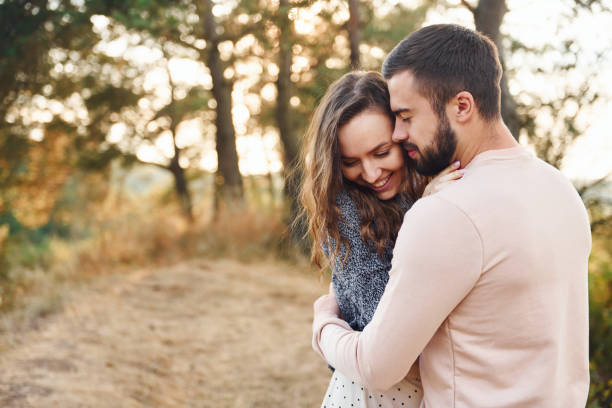 istock Embraces each other. Cheerful lovely young couple having a rest outdoors together 1330207314