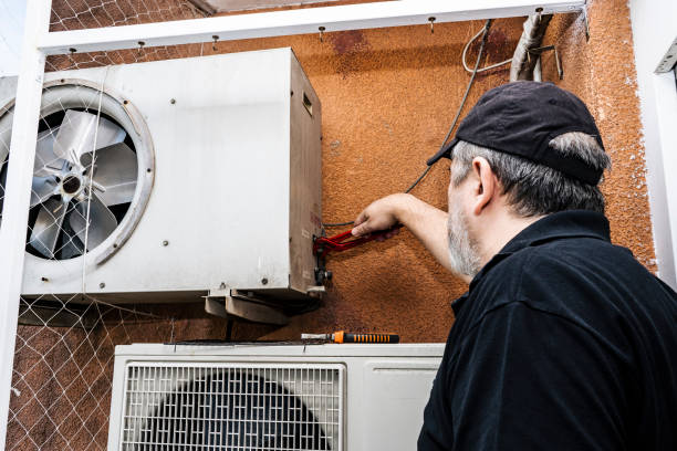 istock Professional air conditioning technician adjusting the refrigerant outlets on an external unit of a old split air unit. 1330208674