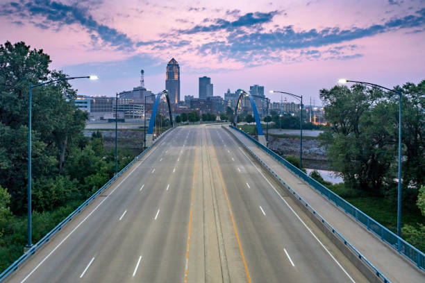 Sunrise over the George Washington Carver Bridge Sunrise over the George Washington Carver Bridge and the downtown Des Moines skyline iowa stock pictures, royalty-free photos & images