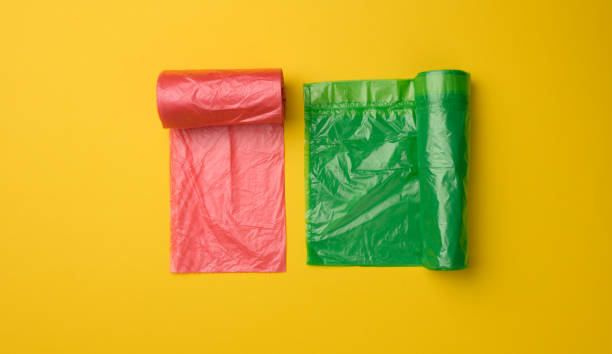 istock green and red plastic bags for trash can on yellow background 1330218117
