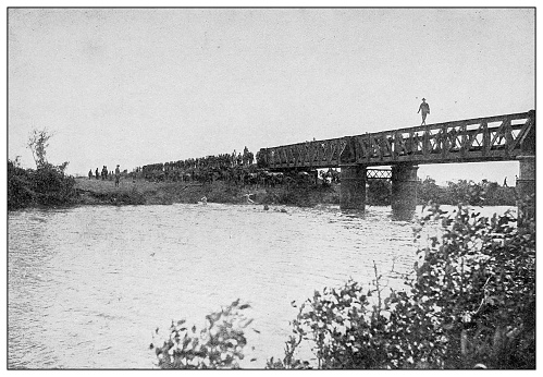 Antique black and white photograph of people from islands in the Caribbean and in the Pacific Ocean; Cuba, Hawaii, Philippines and others: railroad bridge, Bulacan, Philippines