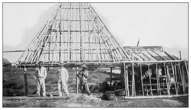 старинная черно-белая фотография: каркас строительства филиппинского дома - historical site stock illustrations