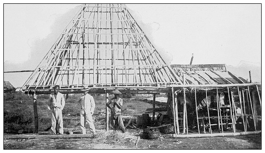 Antique black and white photograph of people from islands in the Caribbean and in the Pacific Ocean; Cuba, Hawaii, Philippines and others: Construction frame of Filipino house