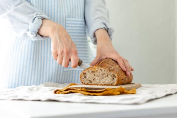 istock women's hands hold bread against the background of a light apron 1330223579